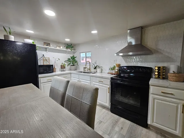 a kitchen with stainless steel appliances granite countertop a stove and a refrigerator
