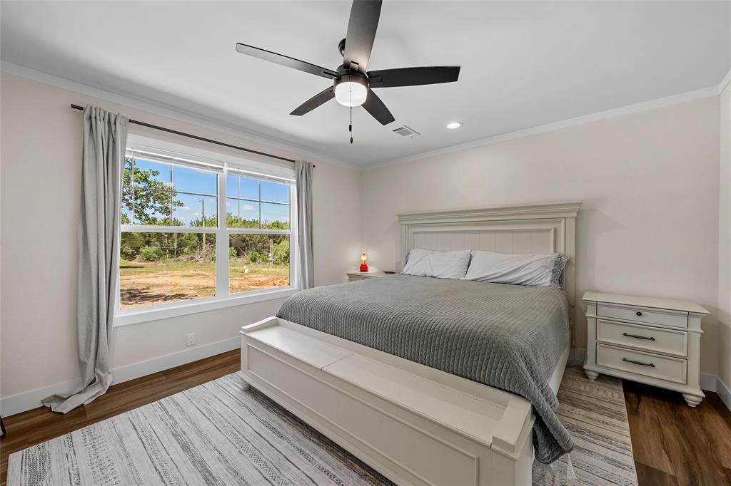 3050 Clater Powell Road Waco, TX 76705 - Photo 21 of 39 a bedroom with a large bed and a large window