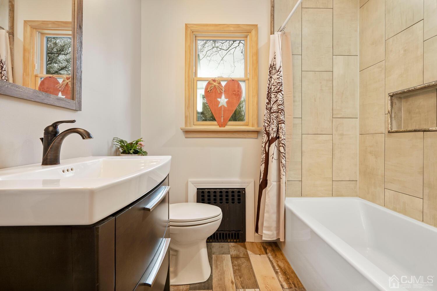 48 Lancaster Road Colonia, NJ 07067 - Photo 13 of 37 a bathroom with a sink and a bathtub