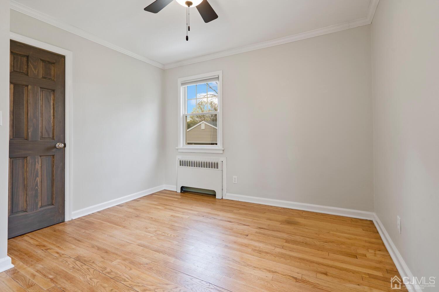 48 Lancaster Road Colonia, NJ 07067 - Photo 15 of 37 wooden floor in an empty room with a window