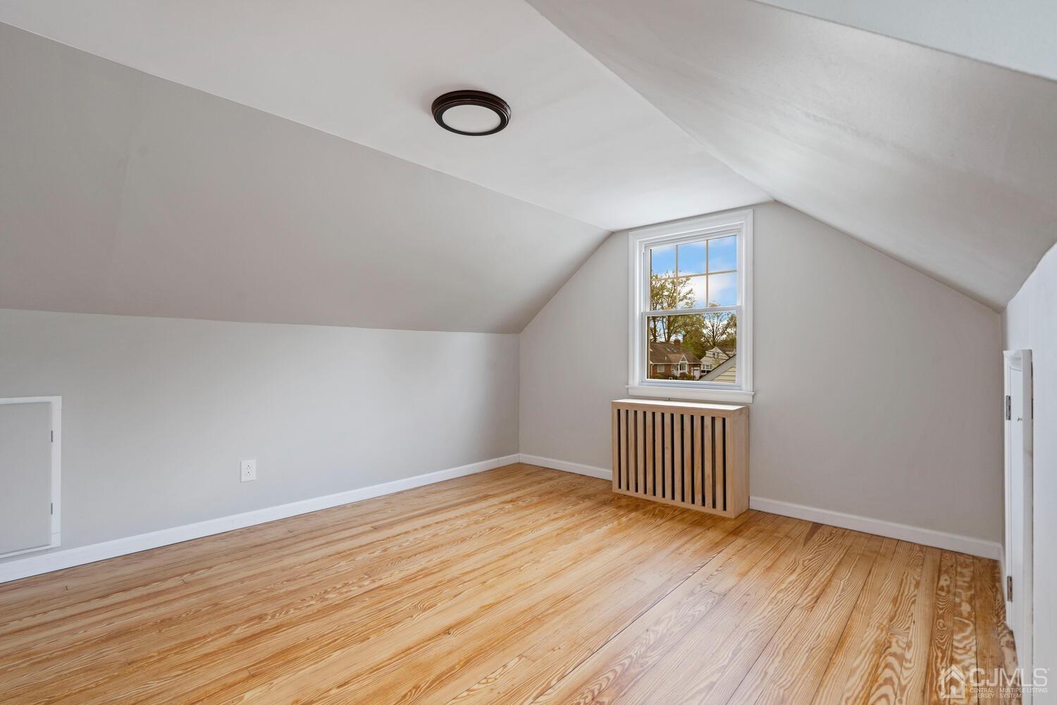 48 Lancaster Road Colonia, NJ 07067 - Photo 17 of 37 an empty room with wooden floor and windows