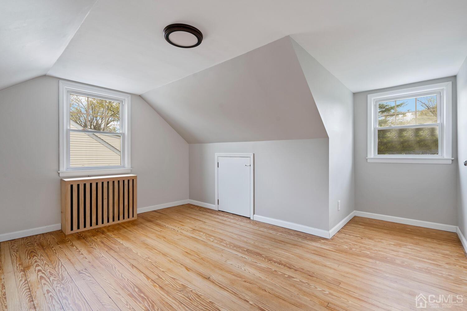 48 Lancaster Road Colonia, NJ 07067 - Photo 18 of 37 a view of an empty room with wooden floor and a window