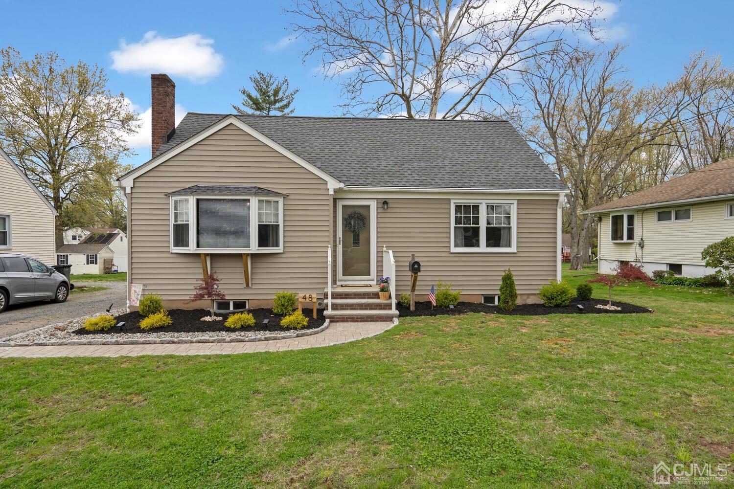 48 Lancaster Road Colonia, NJ 07067 - Photo 2 of 37 a front view of a house with a garden