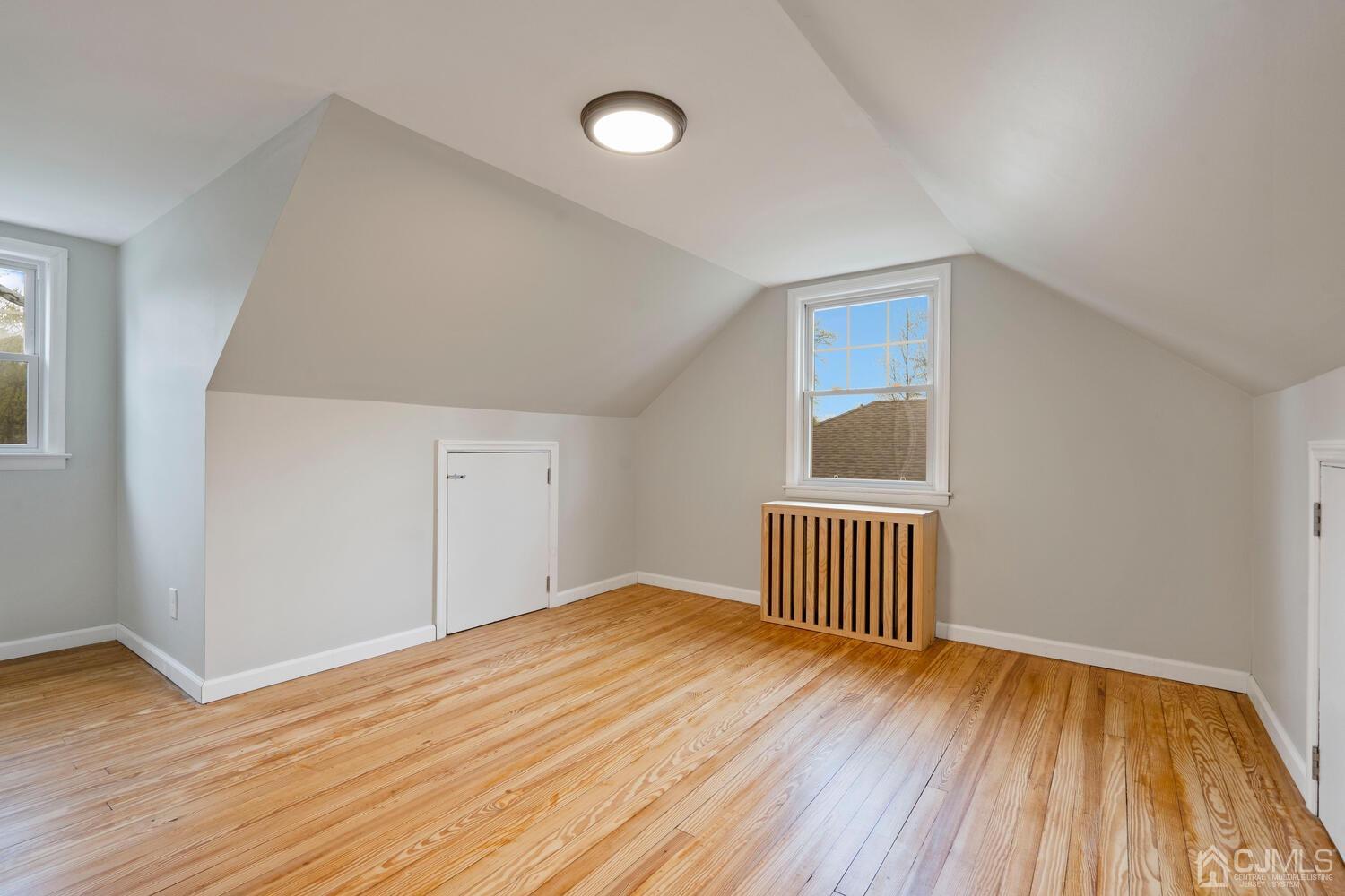 48 Lancaster Road Colonia, NJ 07067 - Photo 21 of 37 a view of an empty room with wooden floor and window