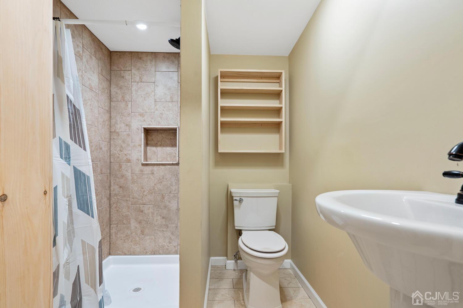 48 Lancaster Road Colonia, NJ 07067 - Photo 24 of 37 a bathroom with a toilet and a sink