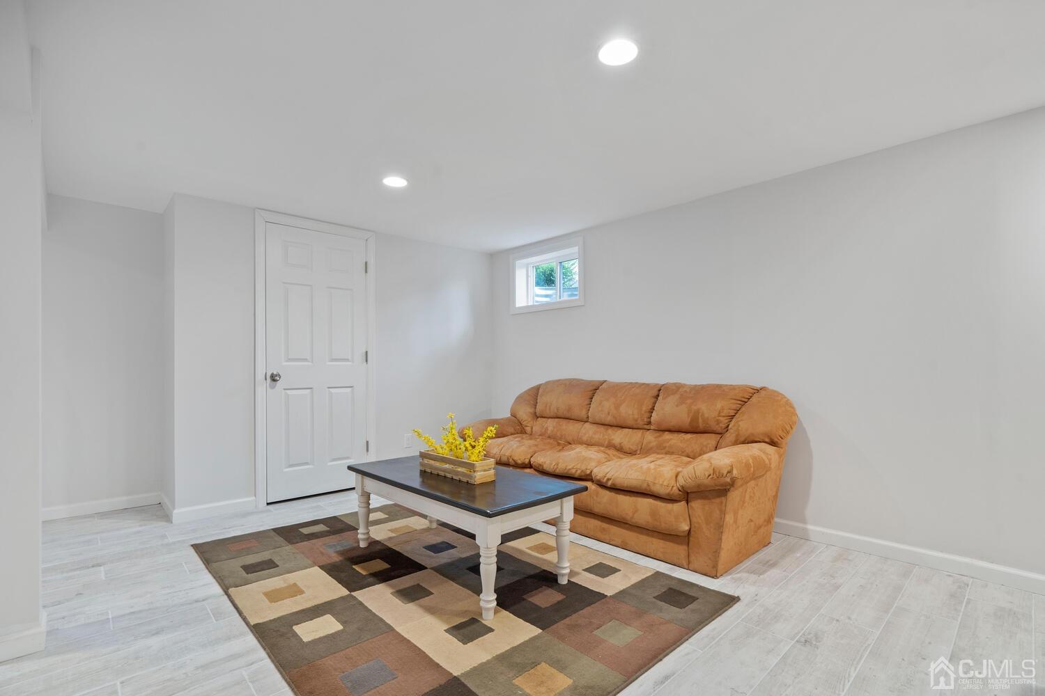 48 Lancaster Road Colonia, NJ 07067 - Photo 28 of 37 a living room with a couch and a coffee table