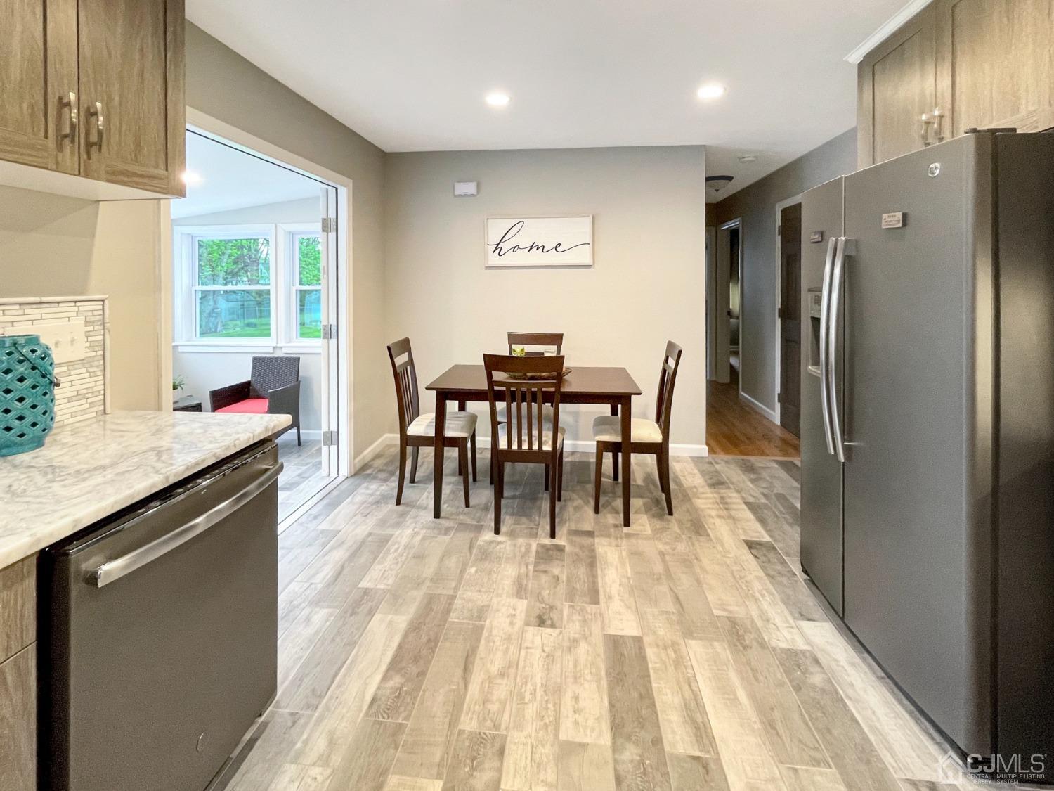 48 Lancaster Road Colonia, NJ 07067 - Photo 3 of 37 a dining hall with stainless steel appliances granite countertop a dining table chairs and granite counter tops