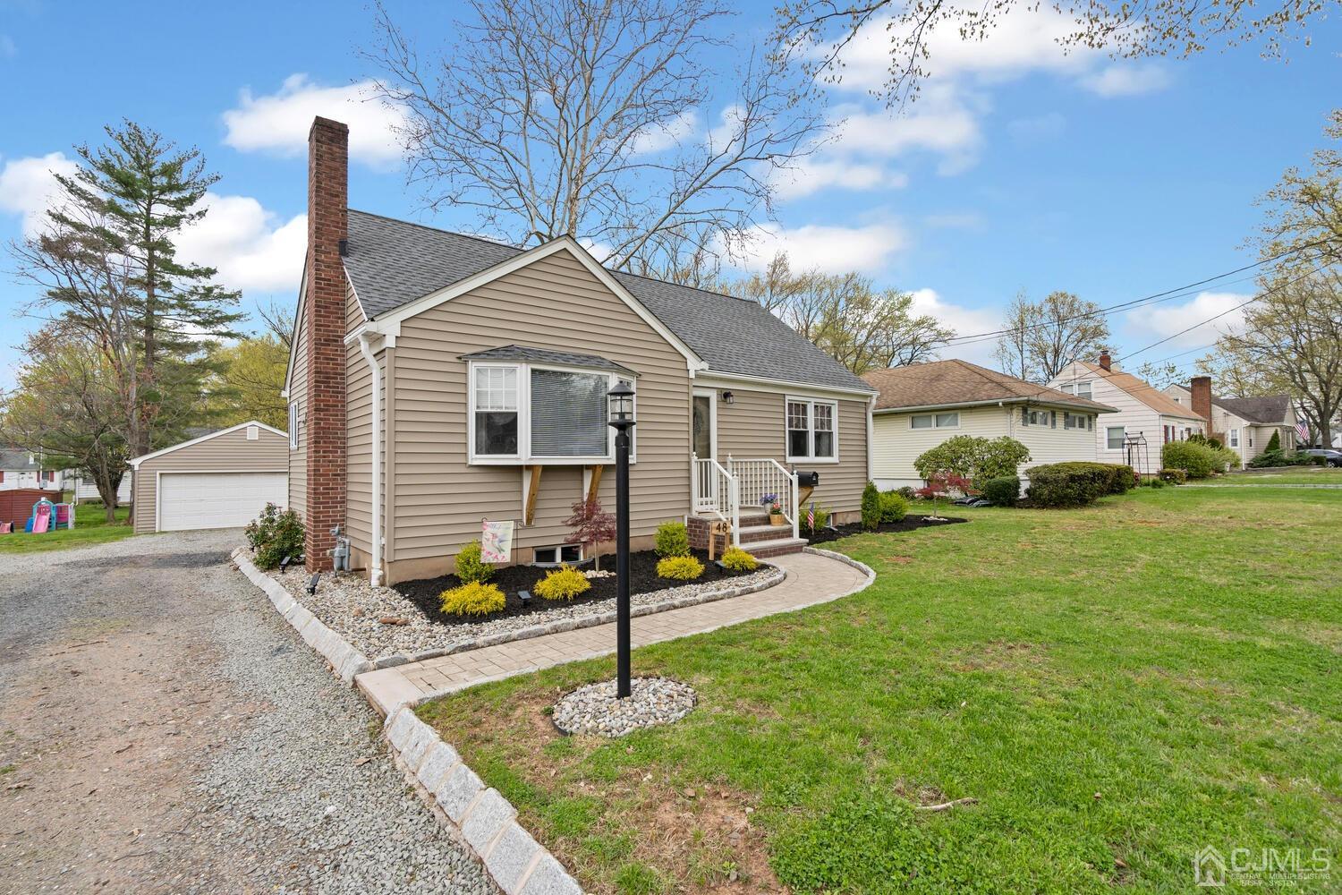 48 Lancaster Road Colonia, NJ 07067 - Photo 31 of 37 a white house that has a small yard and large trees