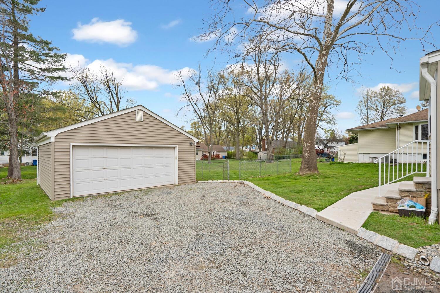 48 Lancaster Road Colonia, NJ 07067 - Photo 32 of 37 a front view of a house with a yard and garage