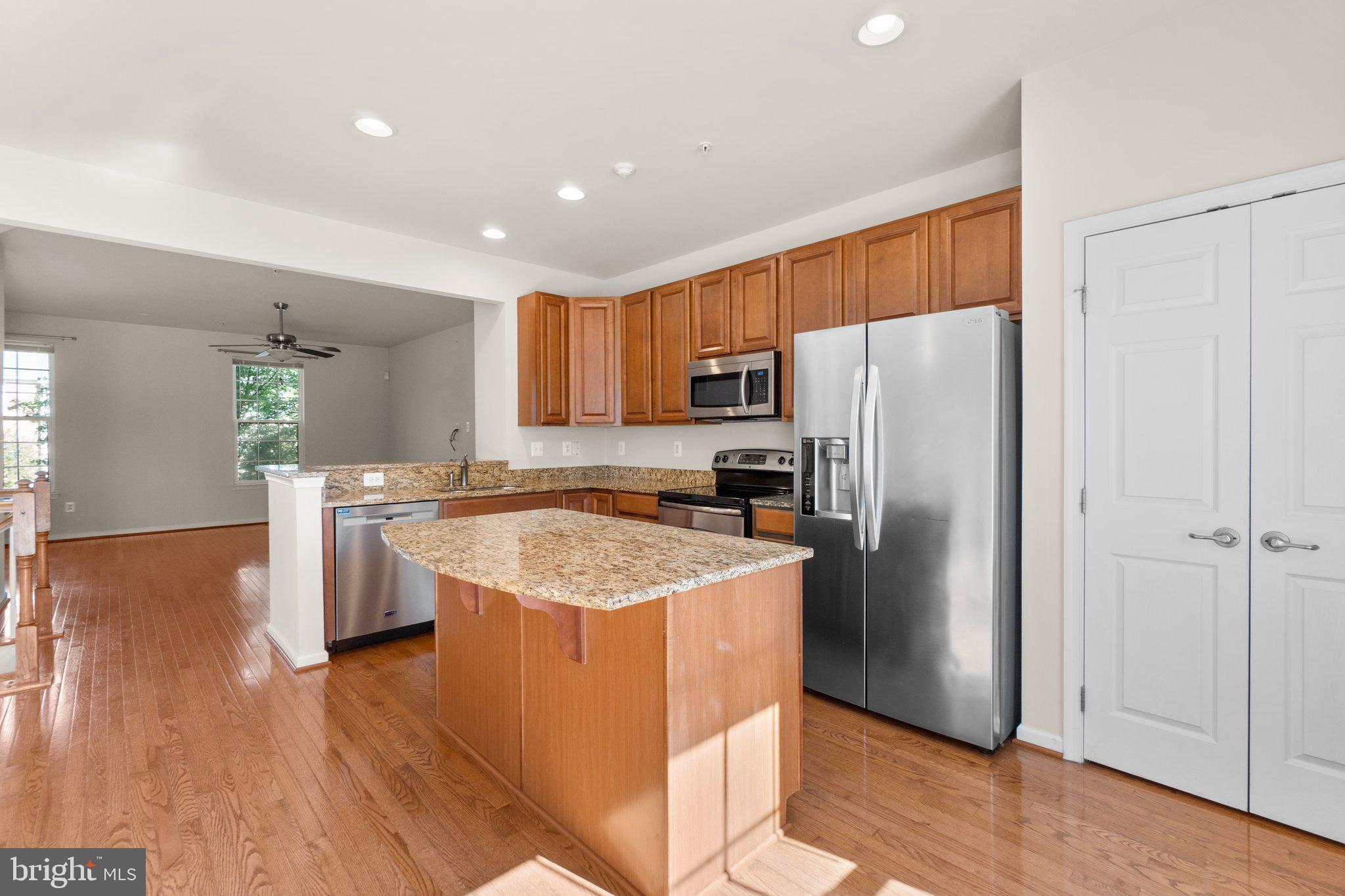 2061 Spring Run Circle Frederick, MD 21702 - Photo 12 of 42 a kitchen with stainless steel appliances granite countertop a refrigerator a sink a stove a microwave and island