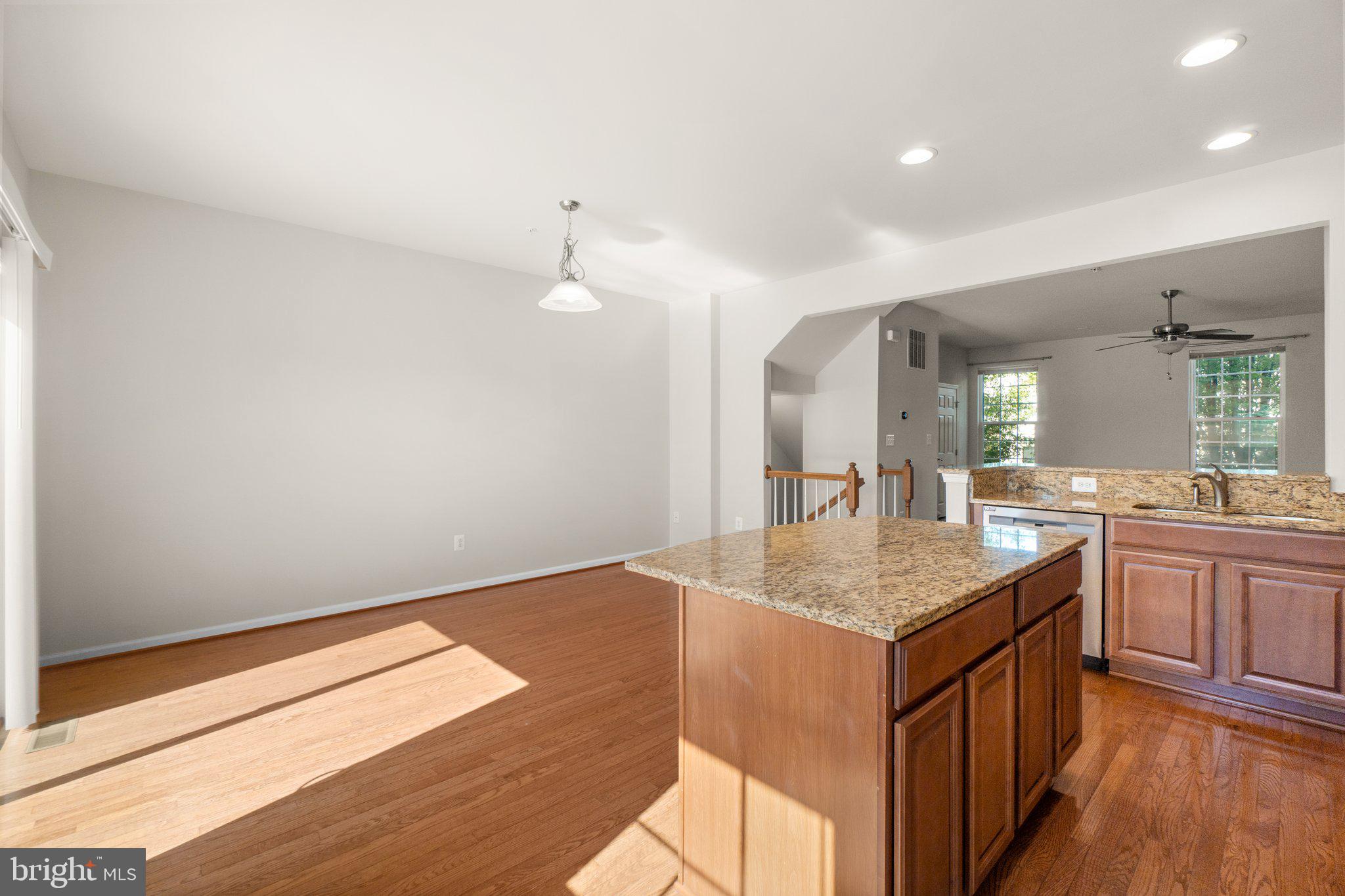 2061 Spring Run Circle Frederick, MD 21702 - Photo 14 of 42 a kitchen with granite countertop a sink cabinets and wooden floor