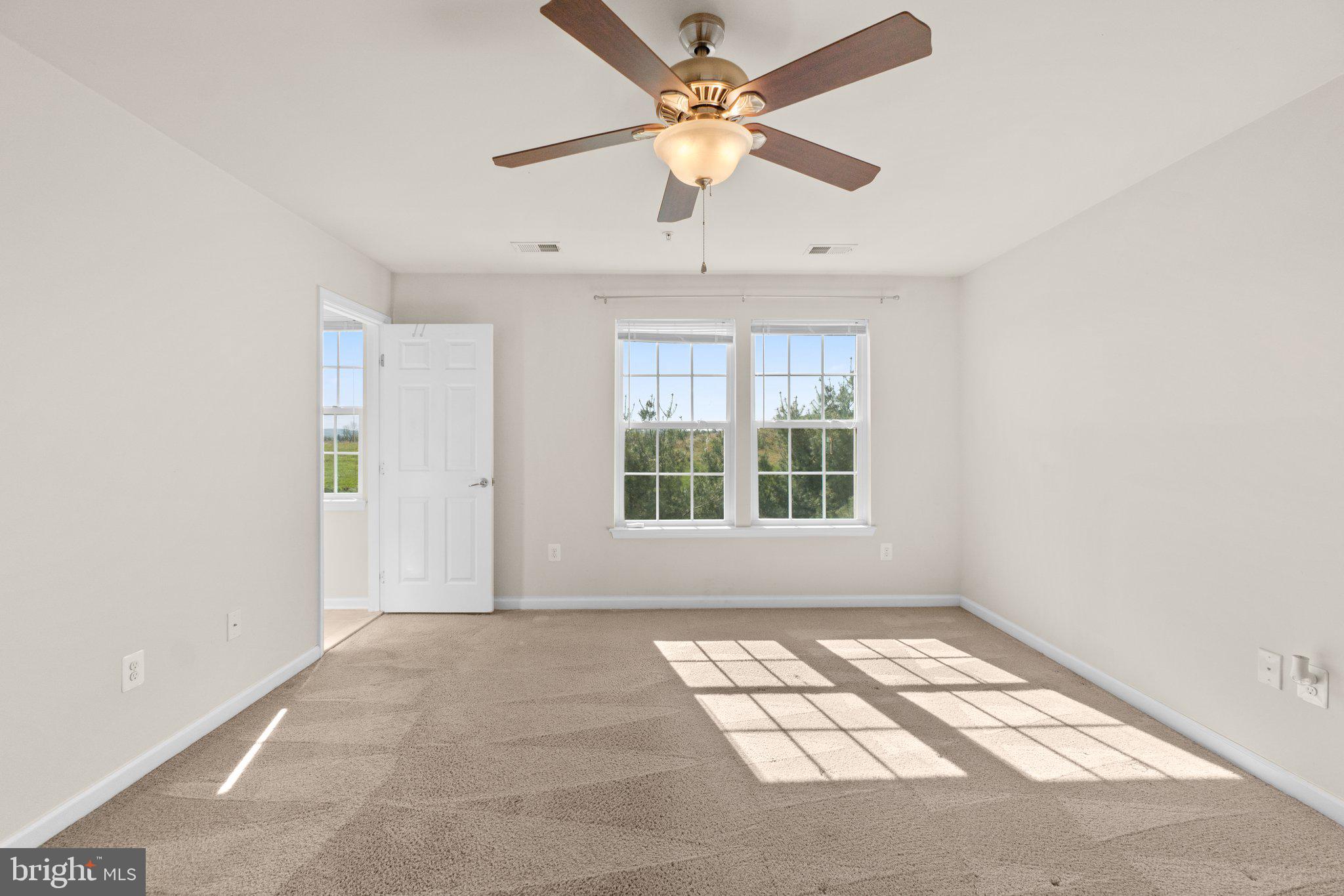 2061 Spring Run Circle Frederick, MD 21702 - Photo 17 of 42 an empty room with windows and fan
