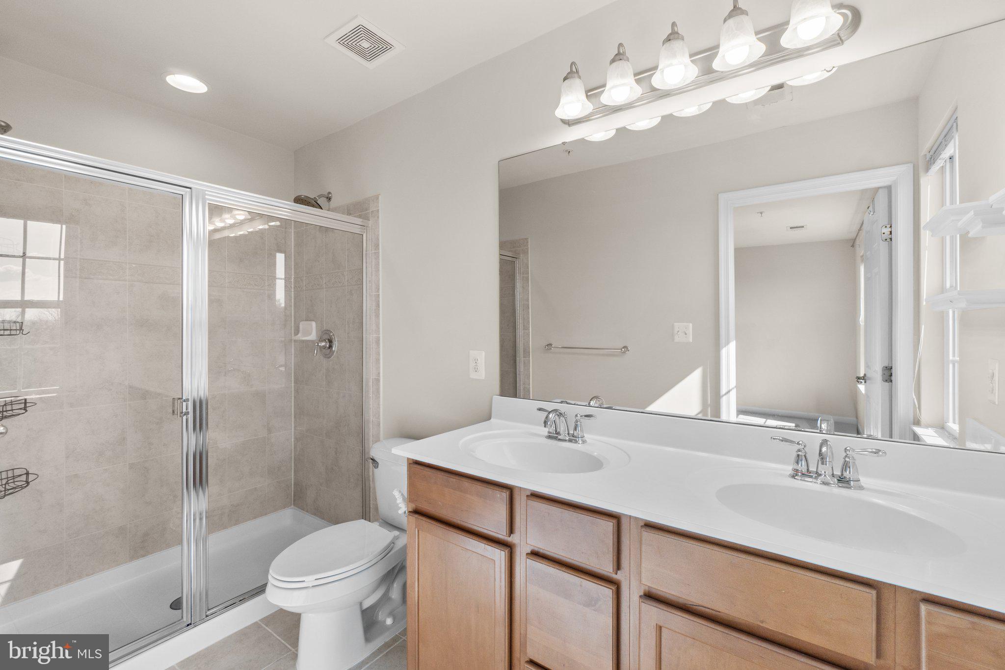 2061 Spring Run Circle Frederick, MD 21702 - Photo 21 of 42 a bathroom with a double vanity sink mirror and toilet