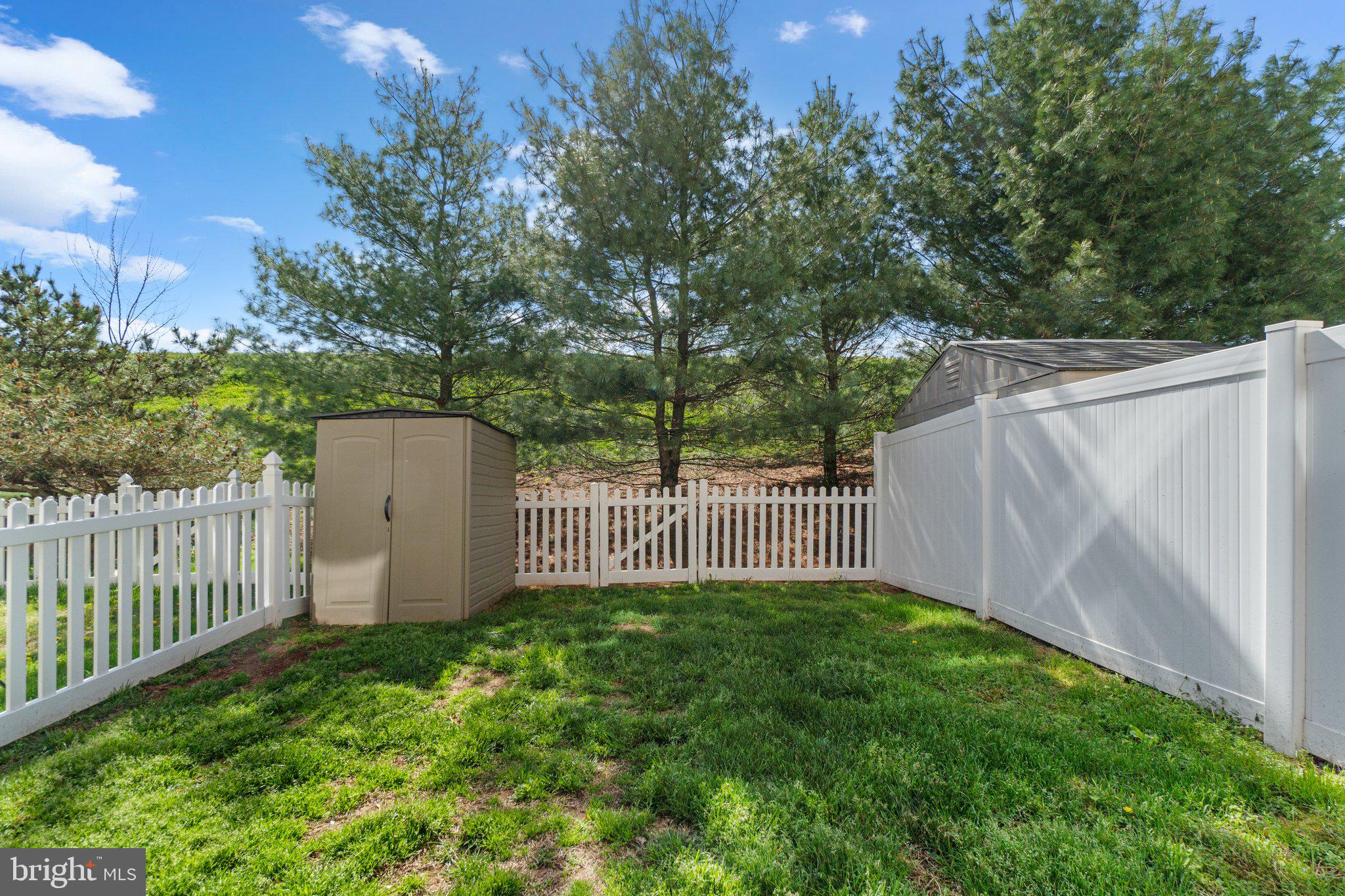 2061 Spring Run Circle Frederick, MD 21702 - Photo 41 of 42 a garden view with a small yard and wooden fence