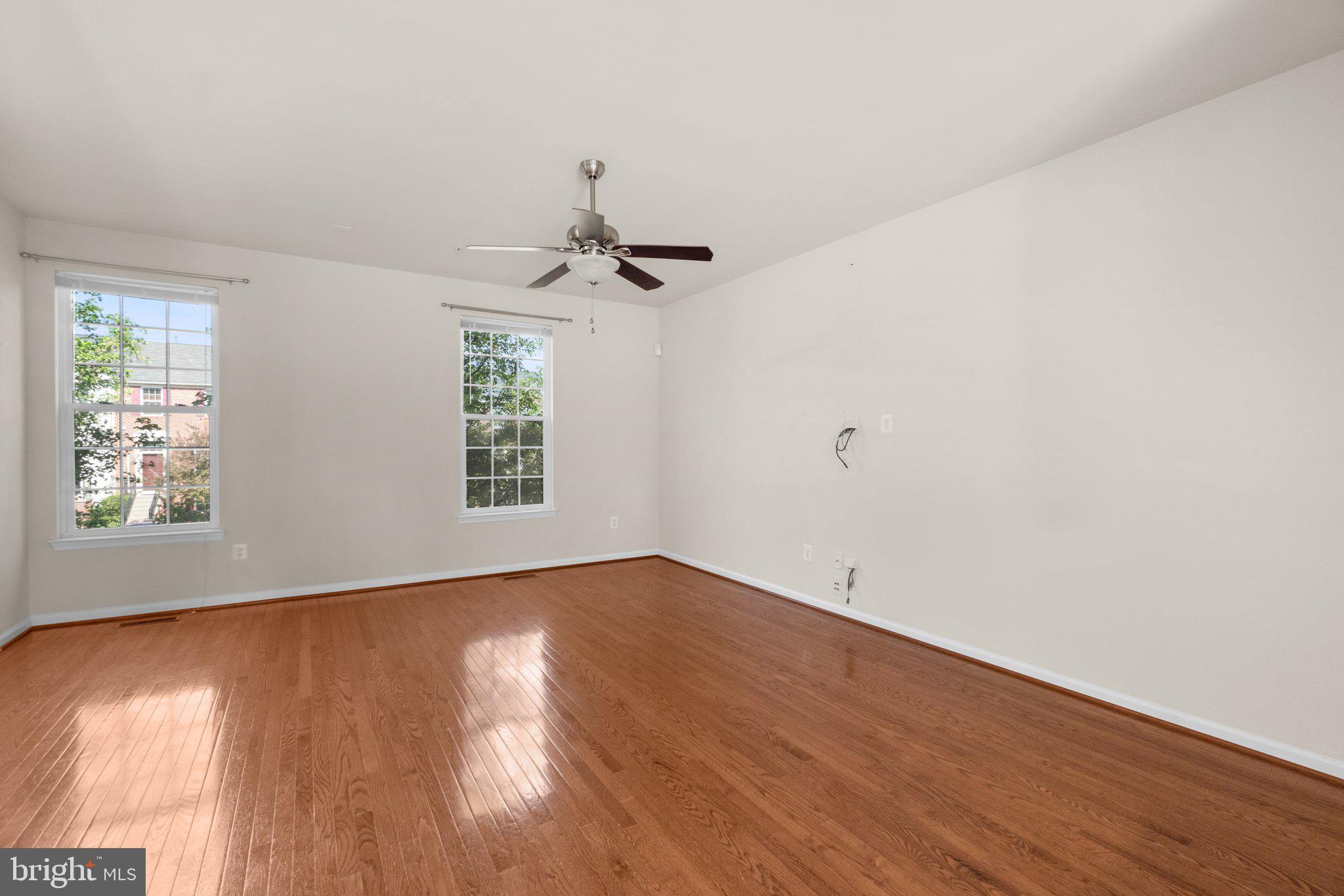 2061 Spring Run Circle Frederick, MD 21702 - Photo 5 of 42 an empty room with wooden floor and windows