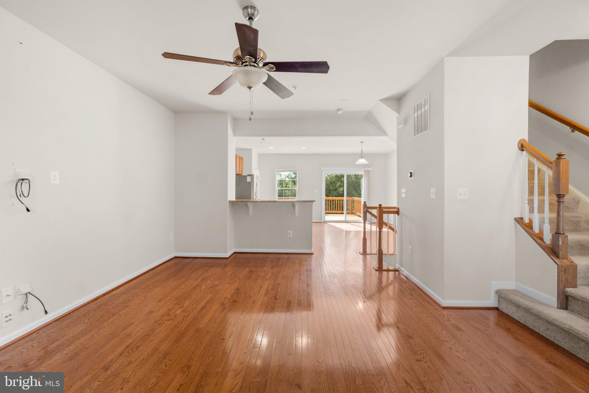 2061 Spring Run Circle Frederick, MD 21702 - Photo 7 of 42 a view of a livingroom with wooden floor and a ceiling fan