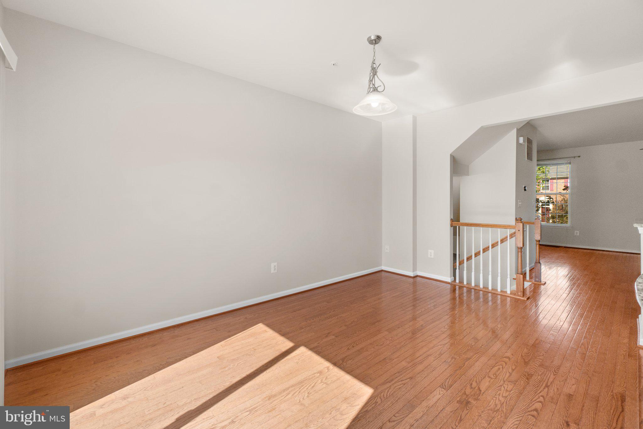 2061 Spring Run Circle Frederick, MD 21702 - Photo 10 of 42 a view of an empty room with wooden floor and a window