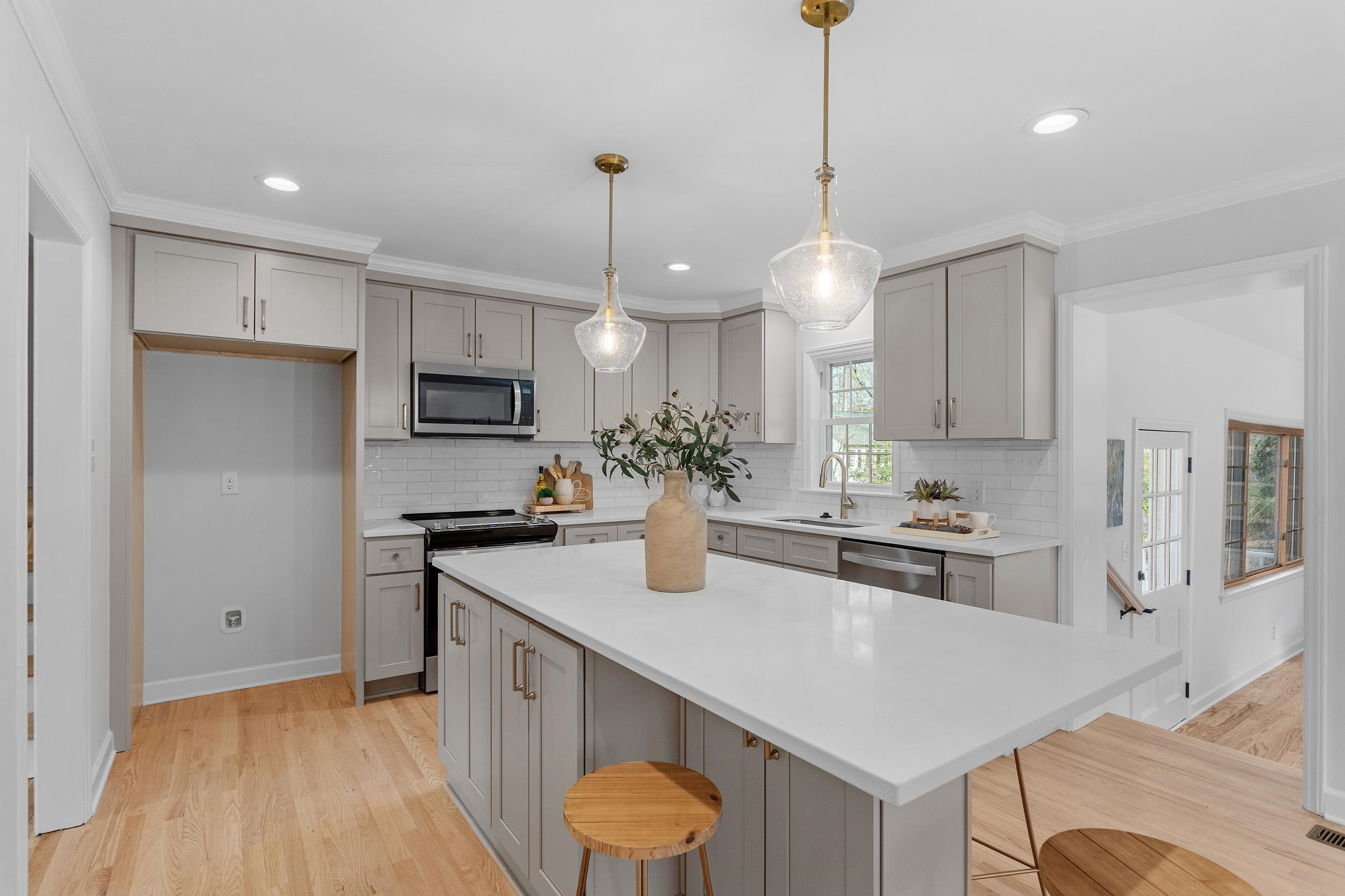 2906 Buckingham Road Durham, NC 27707 - Photo 16 of 34 a kitchen with stainless steel appliances granite countertop a sink a stove a refrigerator a center island and cabinets