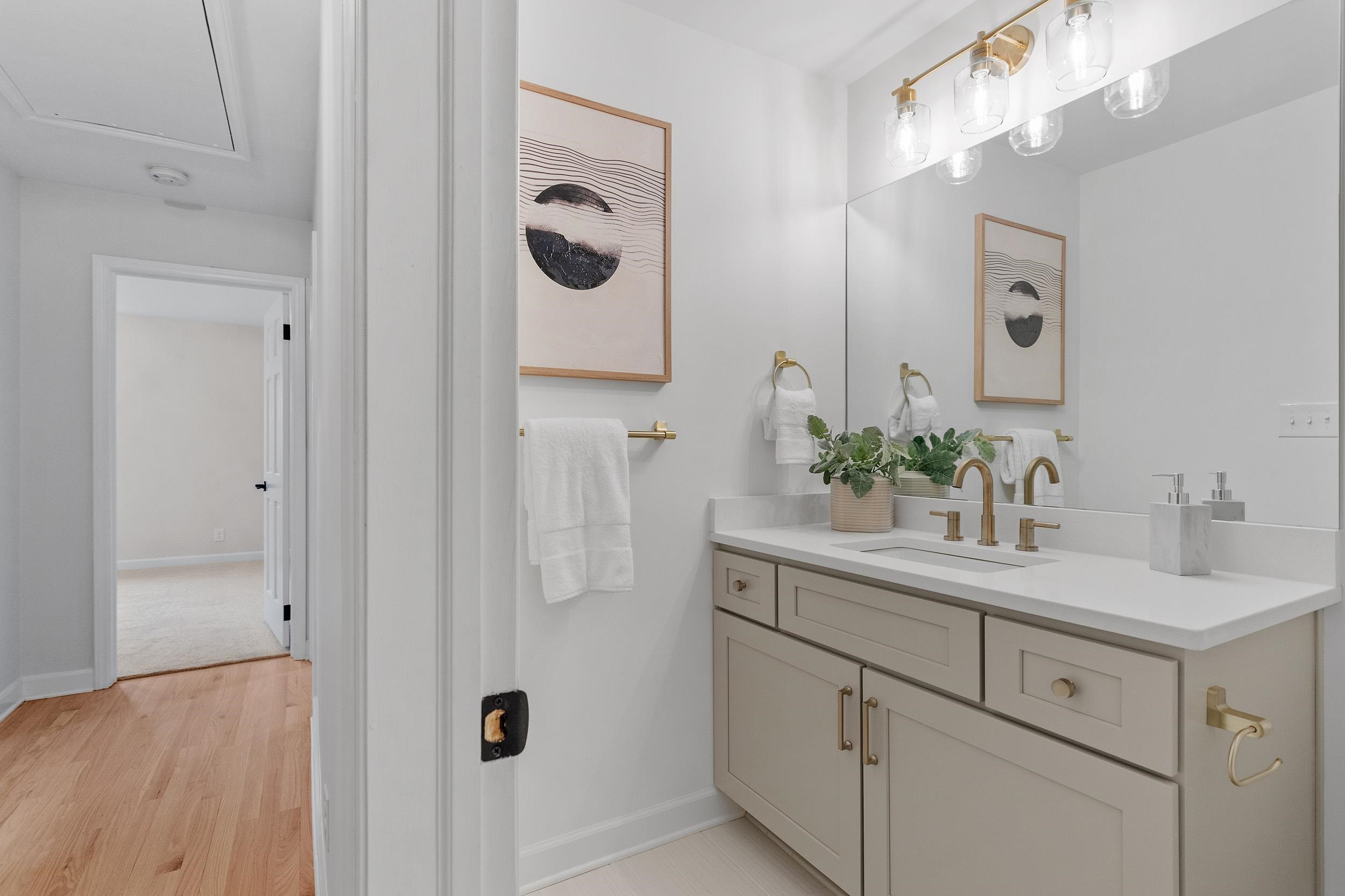 2906 Buckingham Road Durham, NC 27707 - Photo 19 of 34 a bathroom with a sink and mirror