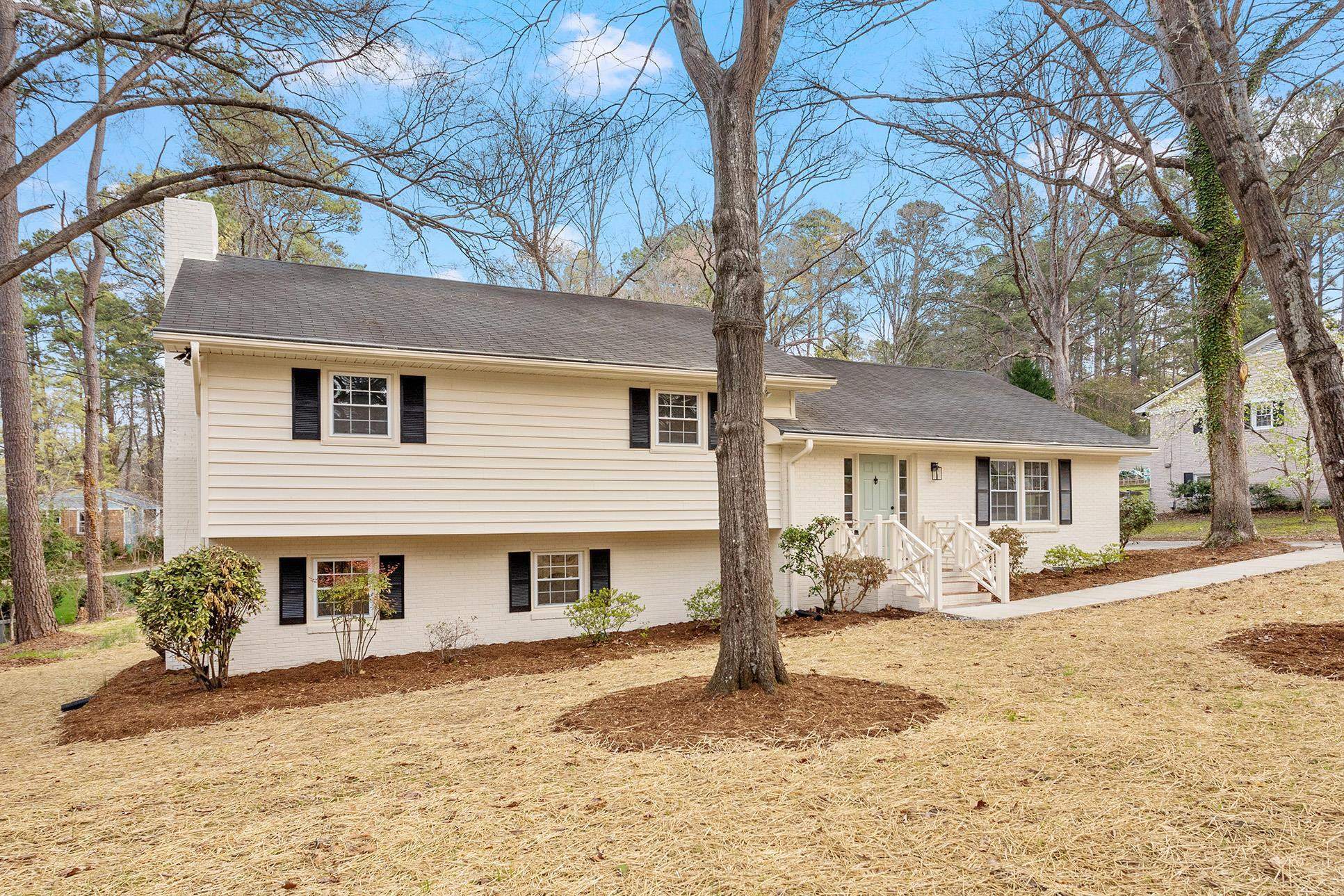2906 Buckingham Road Durham, NC 27707 - Photo 2 of 34 a front view of a house with a yard covered in snow