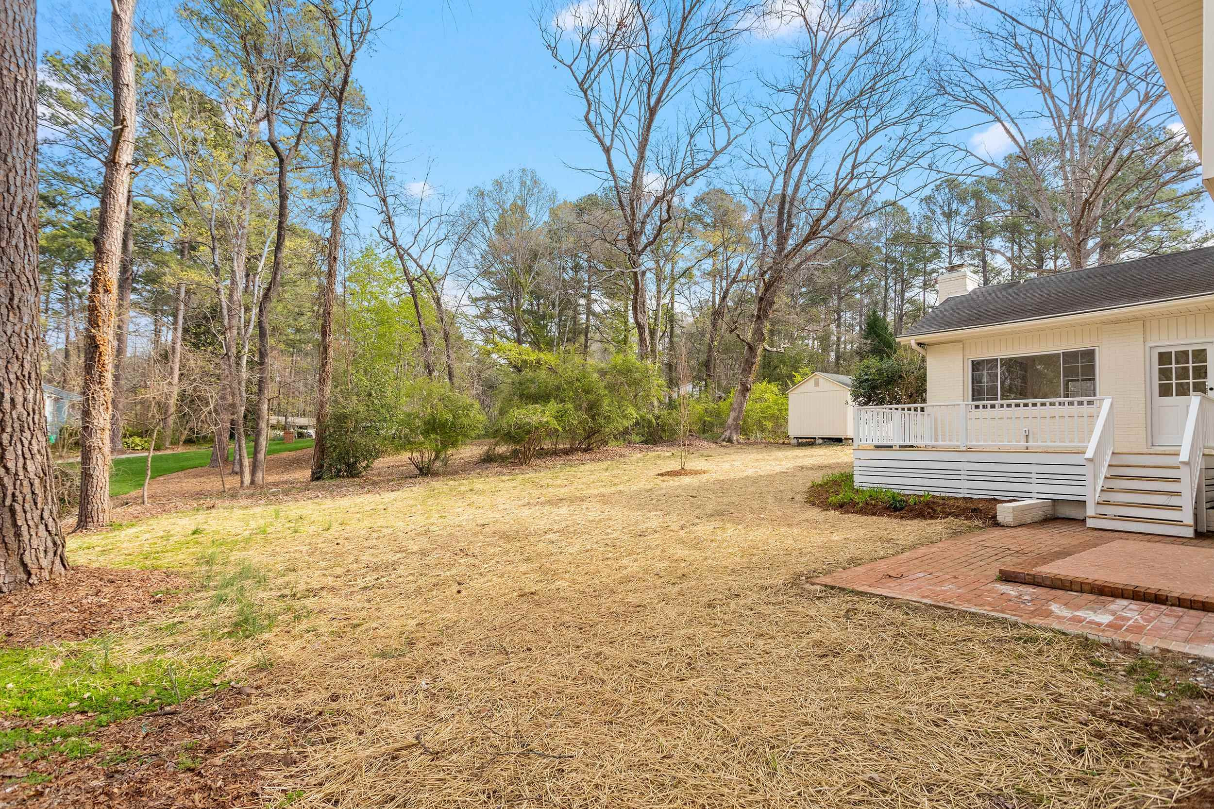 2906 Buckingham Road Durham, NC 27707 - Photo 32 of 34 a backyard of a house with large trees and outdoor space