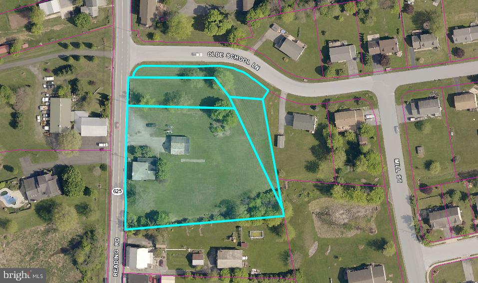 an aerial view of a residential houses with outdoor space