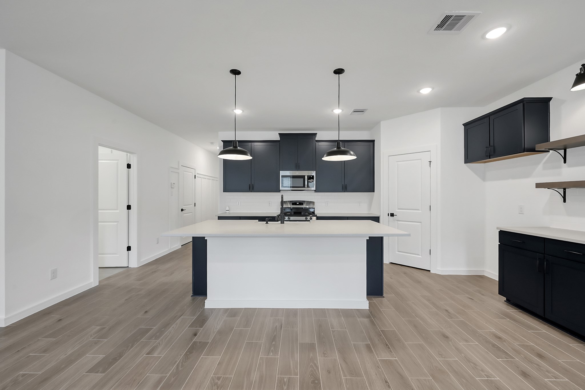 516 Monarch Trail Huntsville, TX 77340 - Photo 6 of 20 a view of kitchen with sink microwave and cabinets