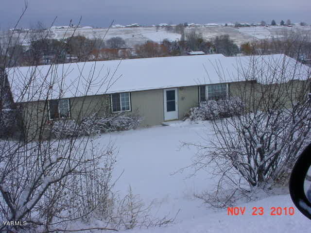 12109 Douglas Road Yakima, WA 98908 - Photo 1 of 5 a front view of a house with a yard and garage