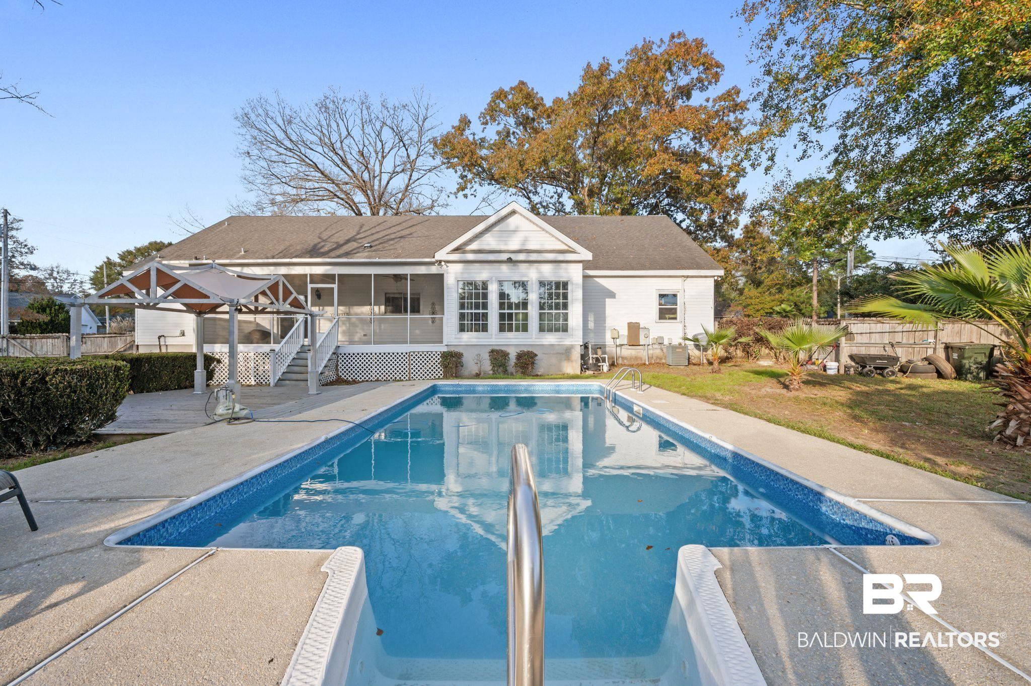 100 Orleans Way Daphne, AL 36526 - Photo 30 of 31 View of swimming pool with a sunroom and a patio