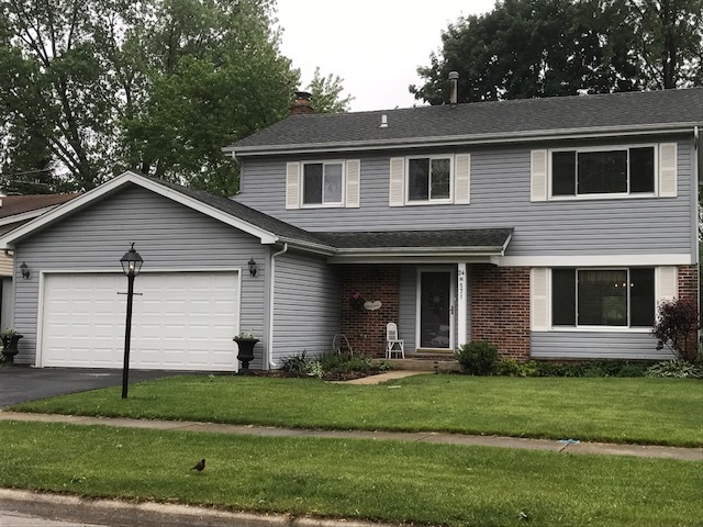 571 Springdale Drive Naperville, IL 60540 - Photo 1 of 1 a front view of a house with a garden and yard