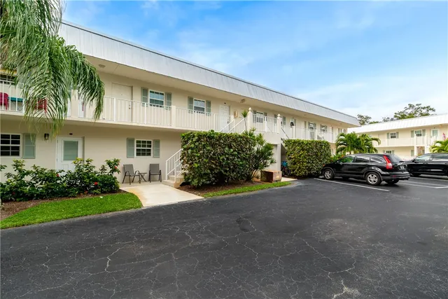 a couple of cars parked in front of a house