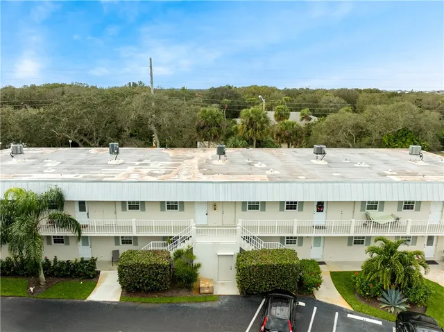 a view of a swimming pool with a terrace and seating area