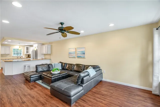 a living room with a couch and a ceiling fan