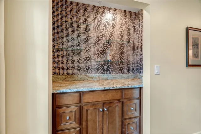 a bathroom with a granite countertop window and a shower