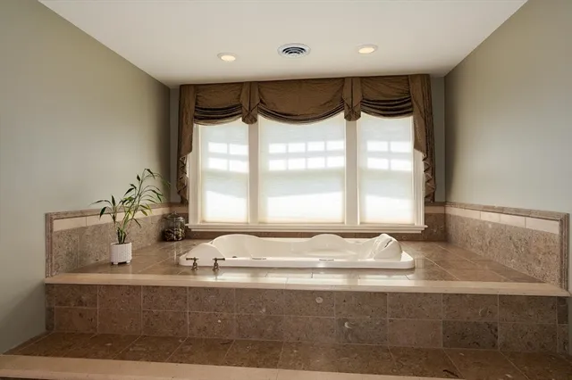 a bathroom with a double vanity sink mirror and shower