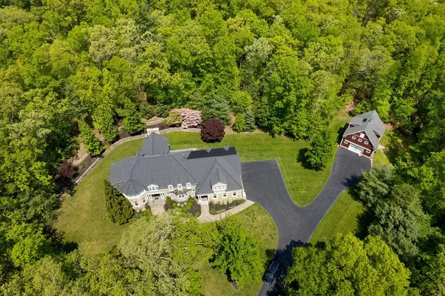 an aerial view of a house with a yard