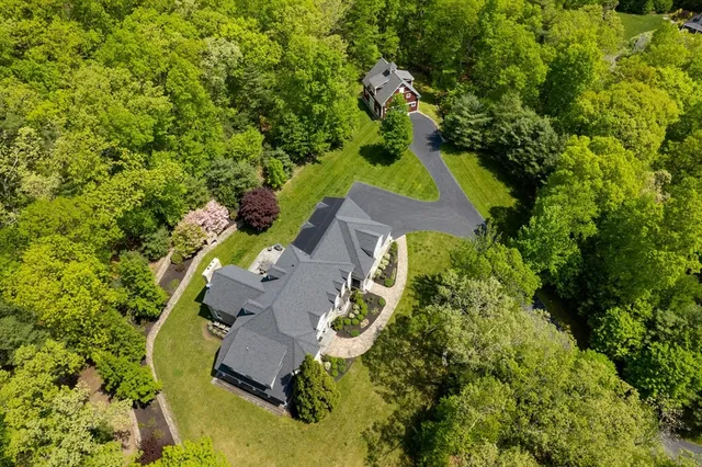 an aerial view of a house with a yard