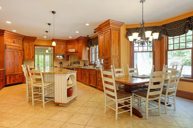 a view of a dining room with furniture and chandelier