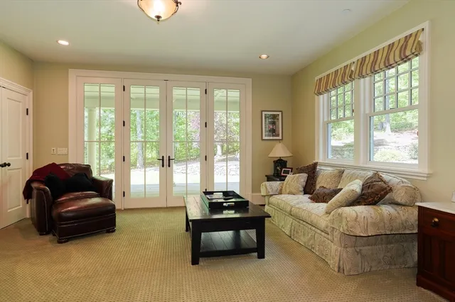 a view of a hallway with wooden floor and windows