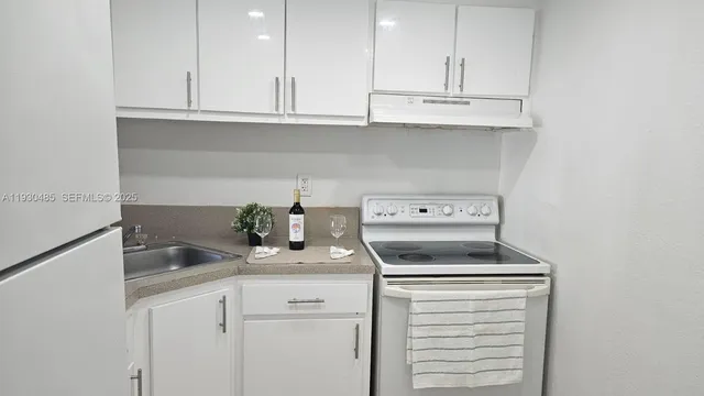 a kitchen with a sink and cabinets