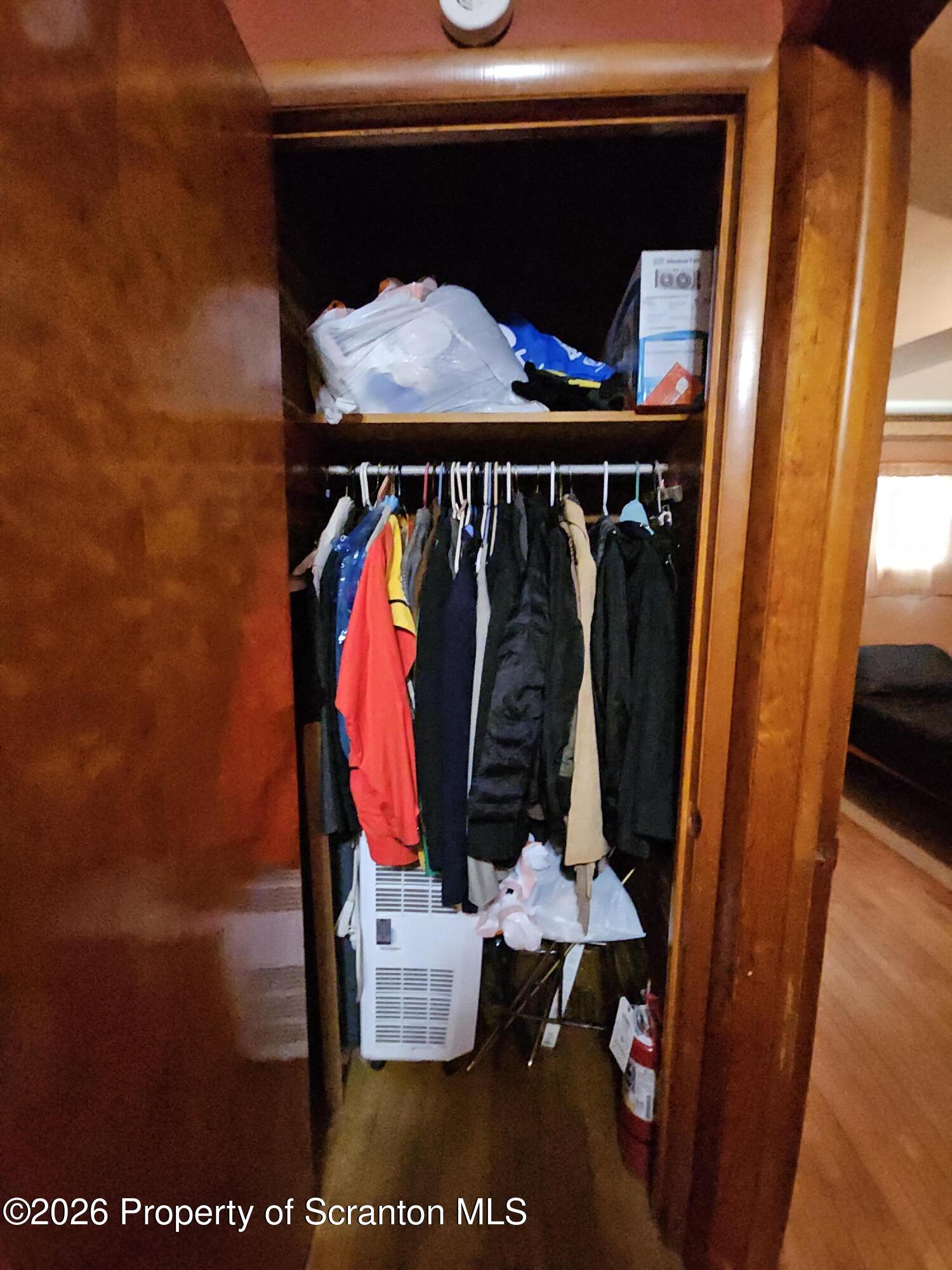 405 Baker Street Taylor, PA 18517 - Photo 27 of 36 a view of walk in closet with clothes and shoes