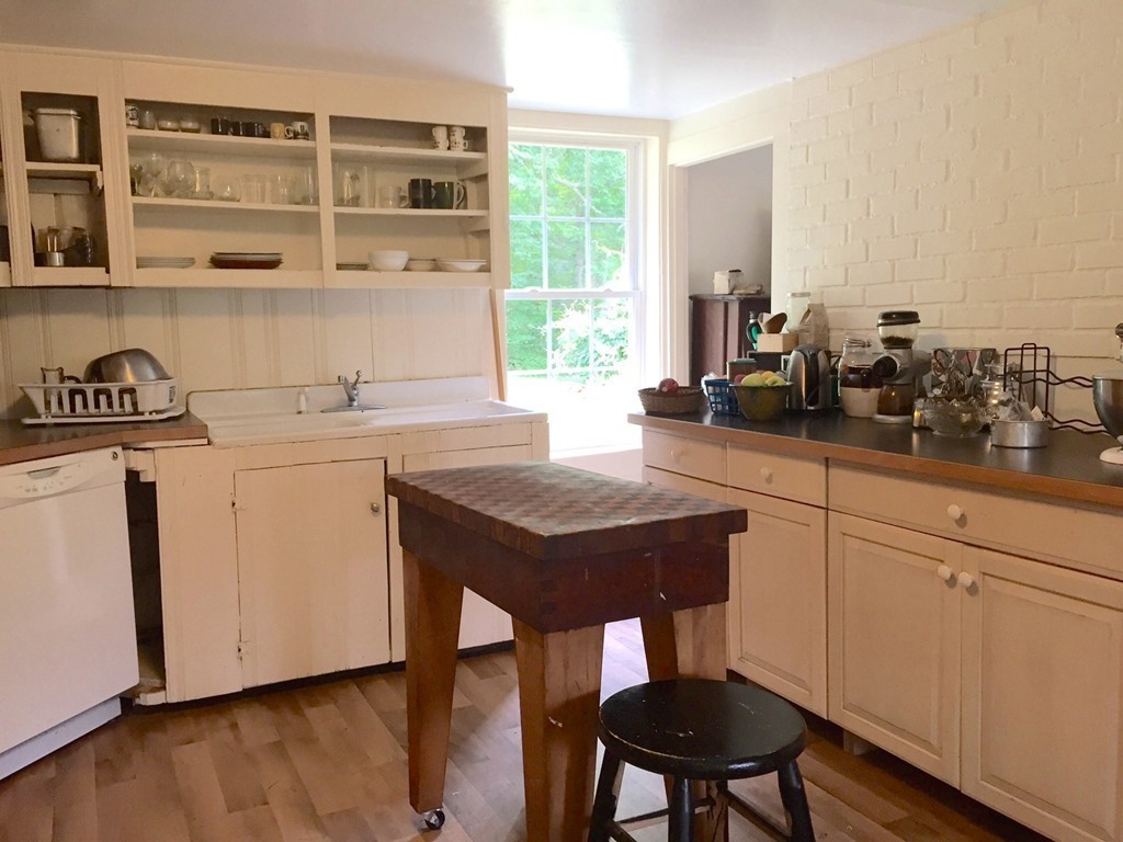 84-86 East Leverett Road Amherst, MA 01002 - Photo 3 of 29 a view of a kitchen with a table and chairs