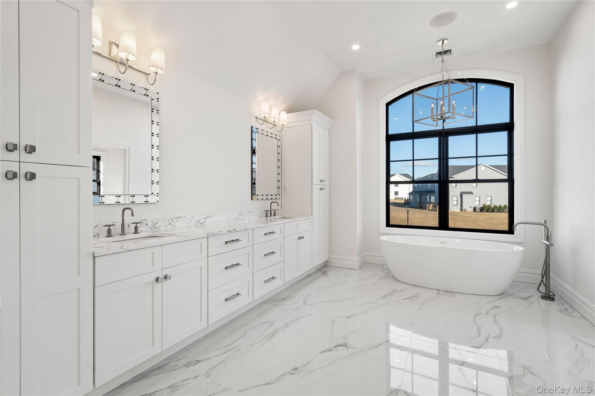 30 Main Parkway Plainview, NY 11803 - Photo 22 of 30 a spacious bathroom with double vanity a bathtub mirror and a sink