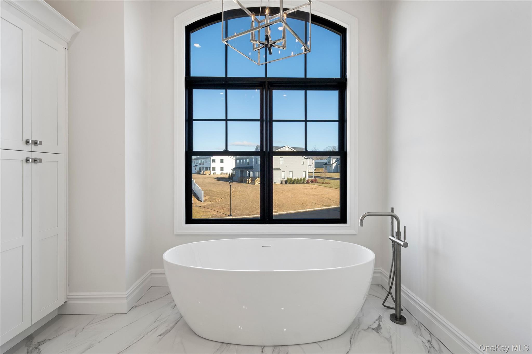 30 Main Parkway Plainview, NY 11803 - Photo 26 of 30 a view of a bath tub sitting in a bathroom