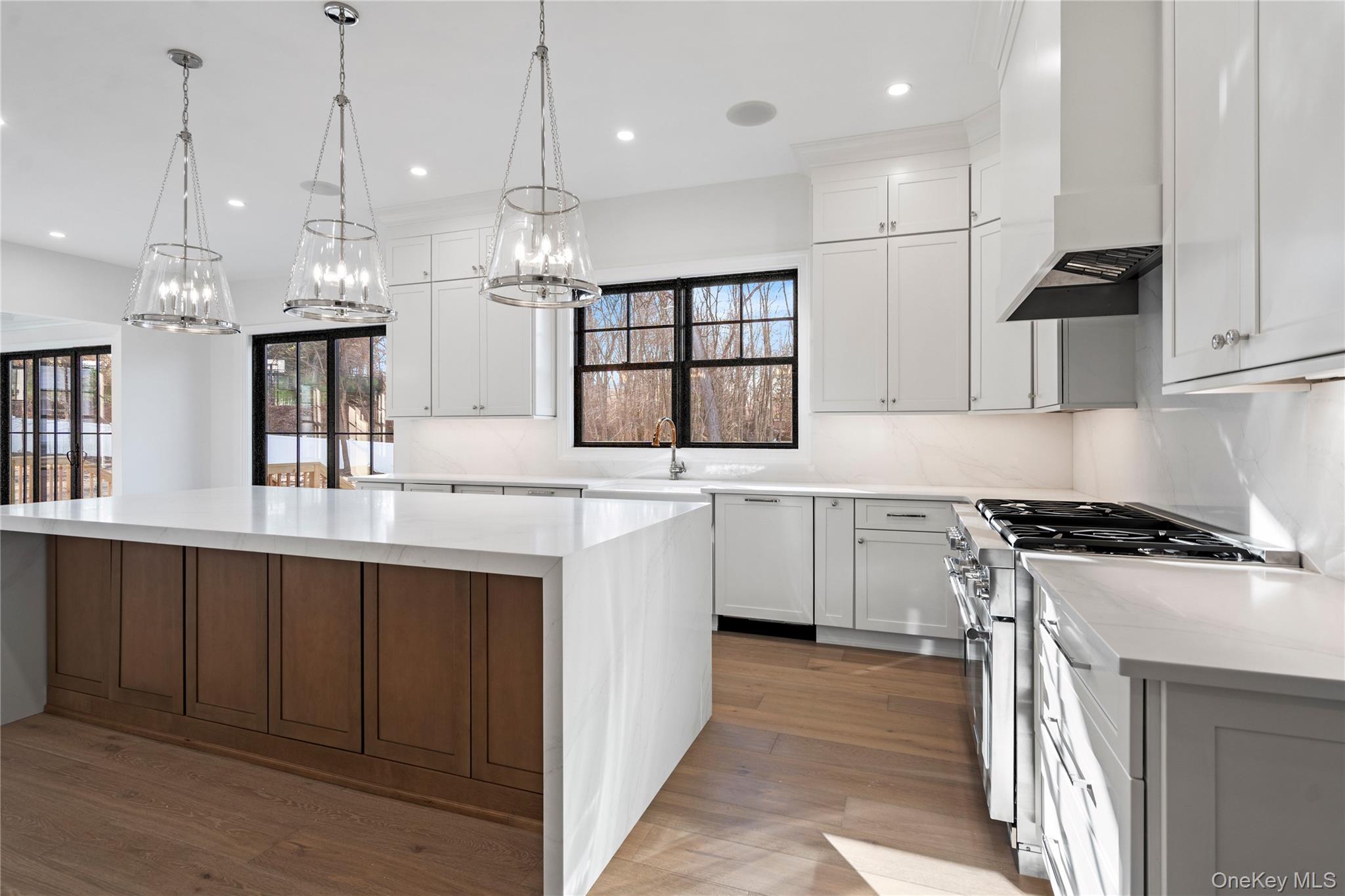 30 Main Parkway Plainview, NY 11803 - Photo 7 of 30 a kitchen with stainless steel appliances granite countertop a sink a stove and a refrigerator