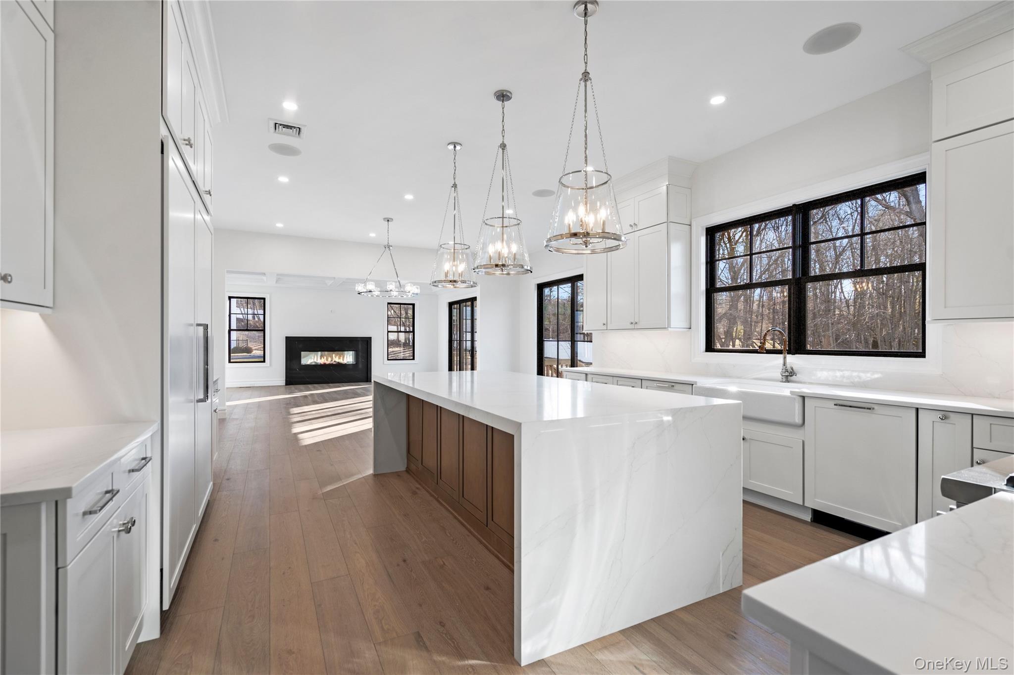 30 Main Parkway Plainview, NY 11803 - Photo 30 of 30 a large white kitchen with lots of counter space wooden floor and appliances