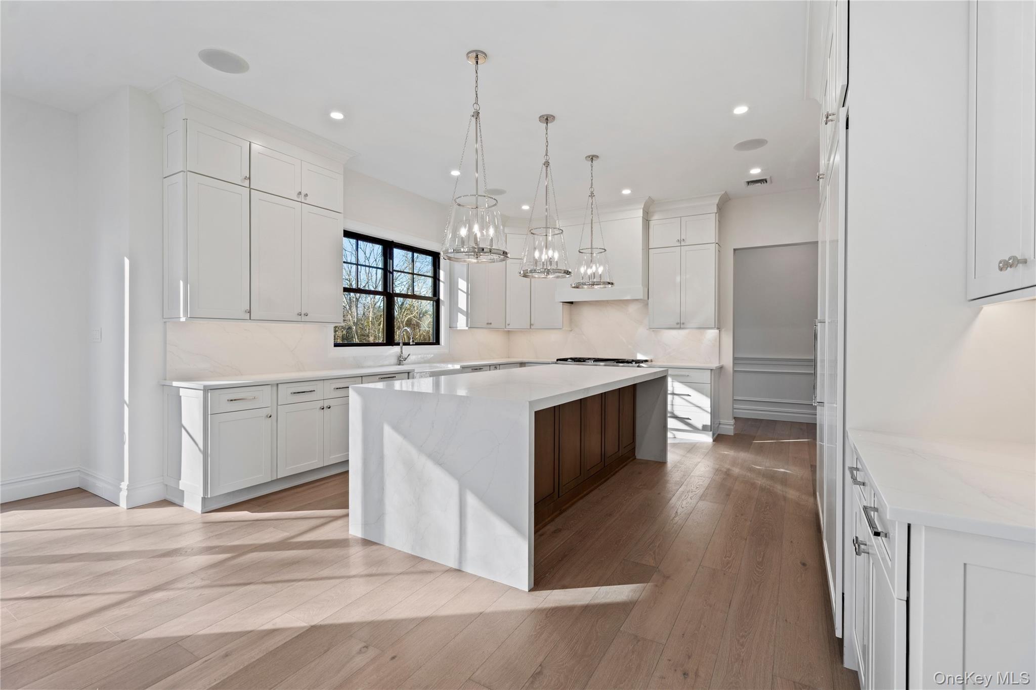 30 Main Parkway Plainview, NY 11803 - Photo 9 of 30 a kitchen with kitchen island a sink stainless steel appliances and cabinets