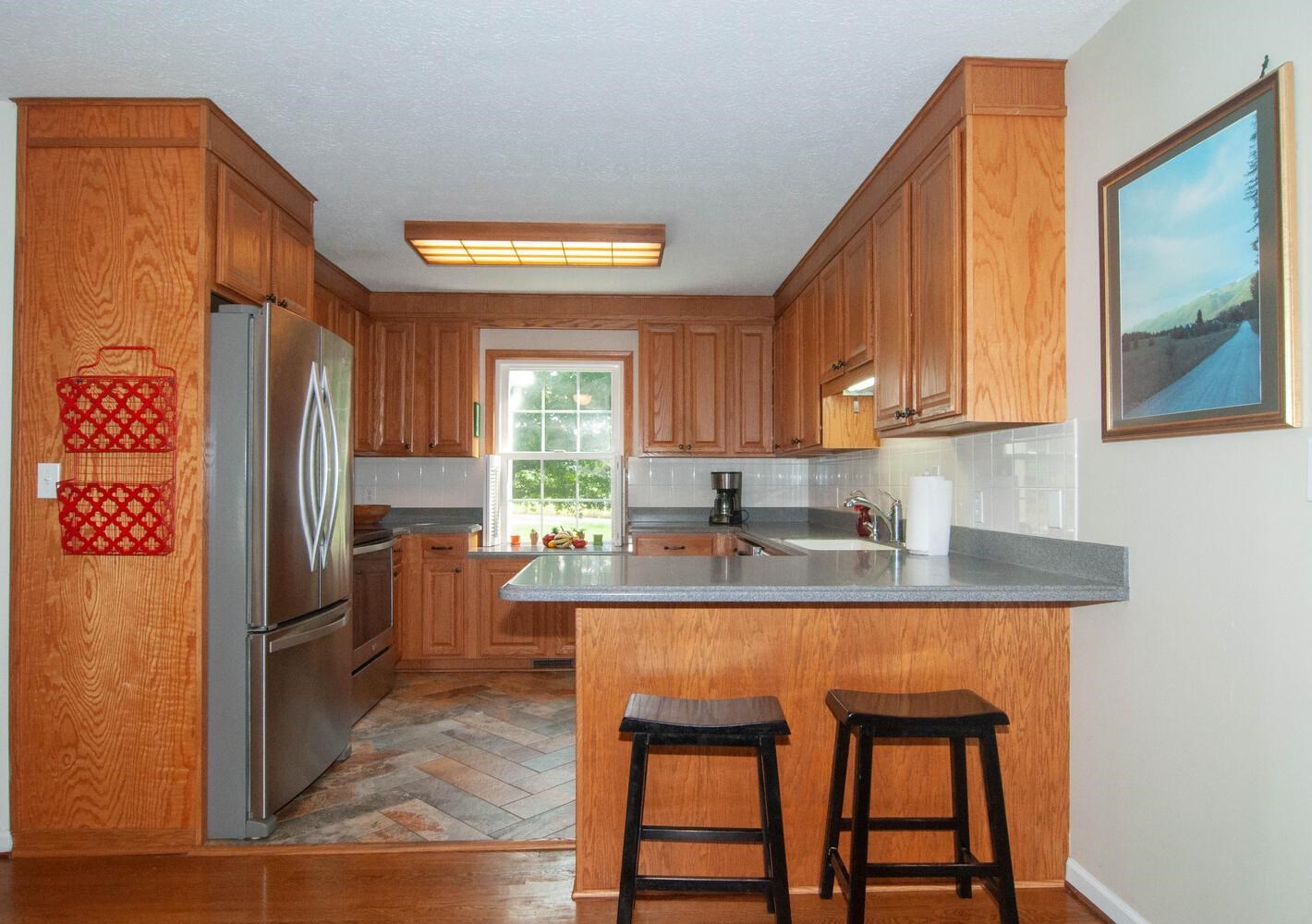 3155 Barterbrook Road Staunton, VA 24401 - Photo 13 of 59 a kitchen with stainless steel appliances granite countertop a refrigerator a stove a sink and dishwasher with wooden floor