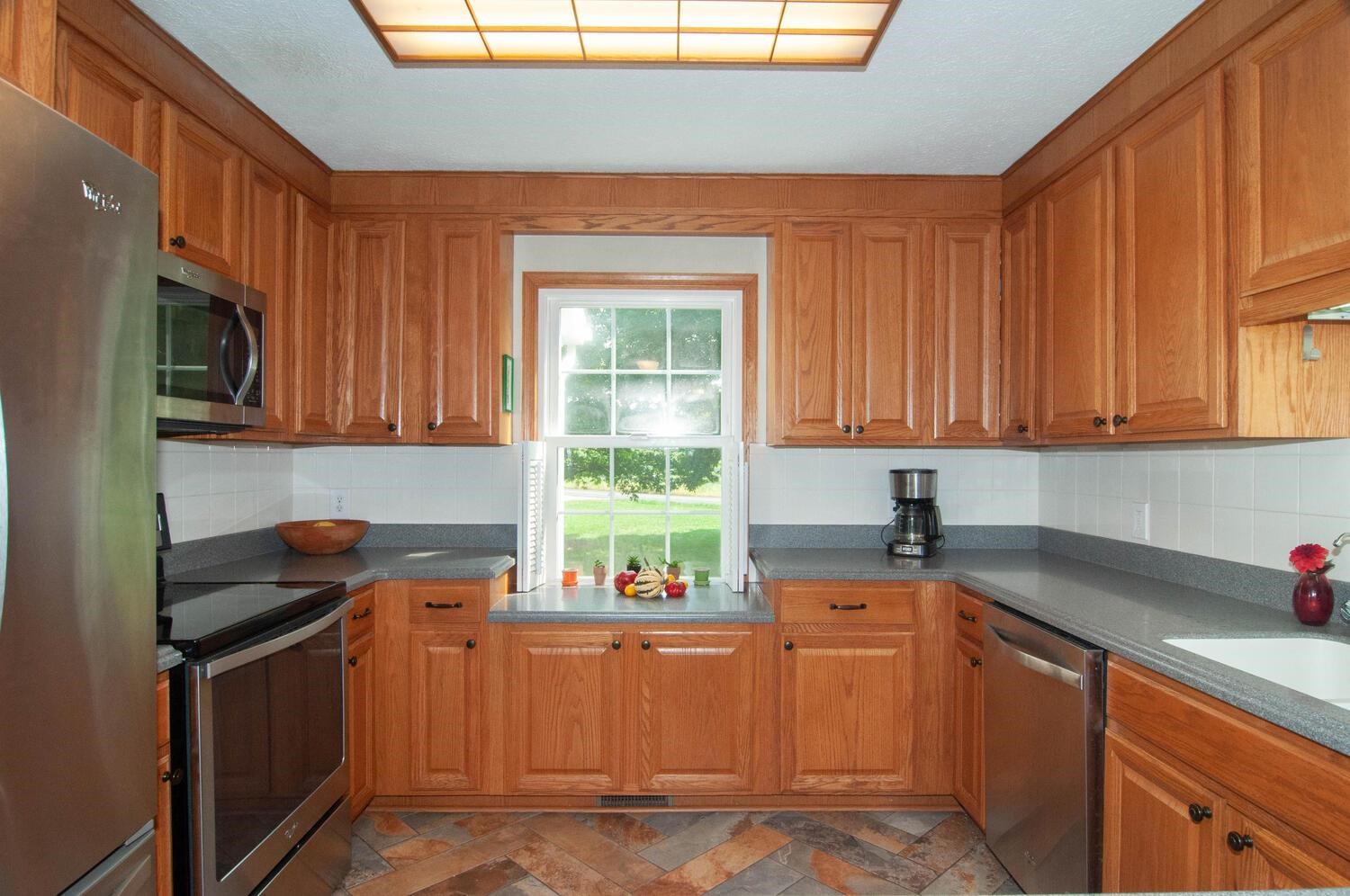 3155 Barterbrook Road Staunton, VA 24401 - Photo 15 of 59 a kitchen with granite countertop cabinets stainless steel appliances a sink and a window