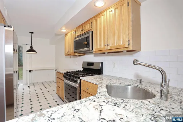 a kitchen with a sink a stove and refrigerator